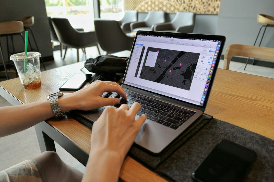 graphic designer using software on laptop